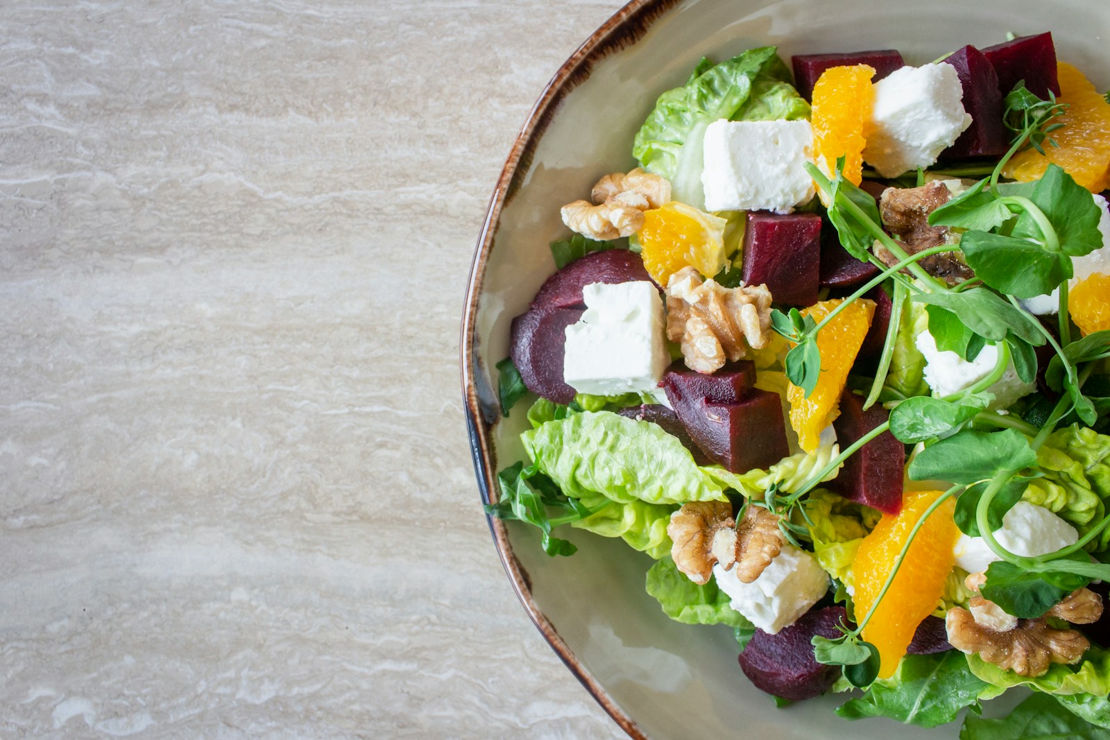 bowl of vegetable salad with walnuts